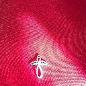 Silver Angel Pendant on Pink Fabric